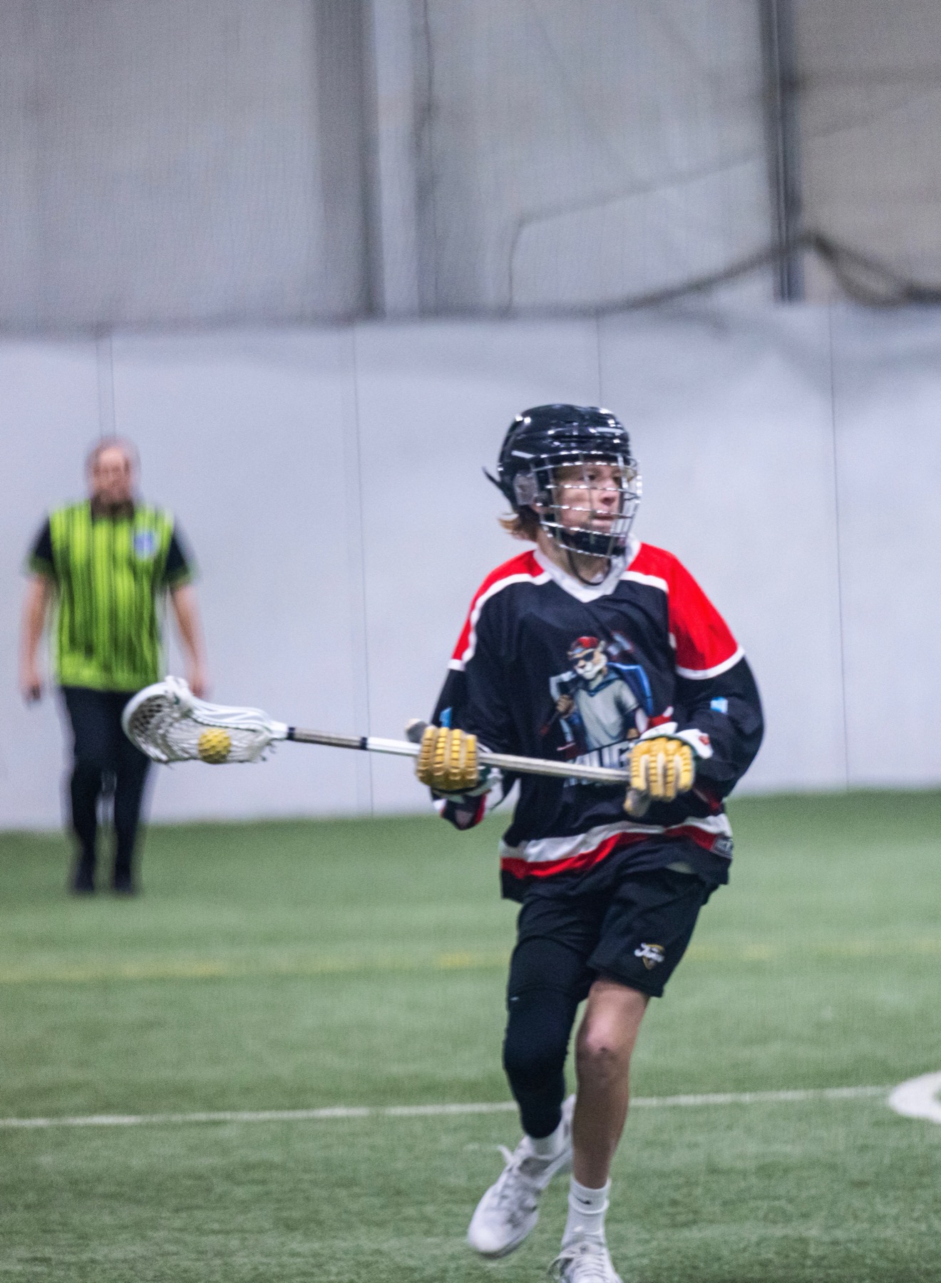 Kougarz box lacrosse player running with the ball during a game