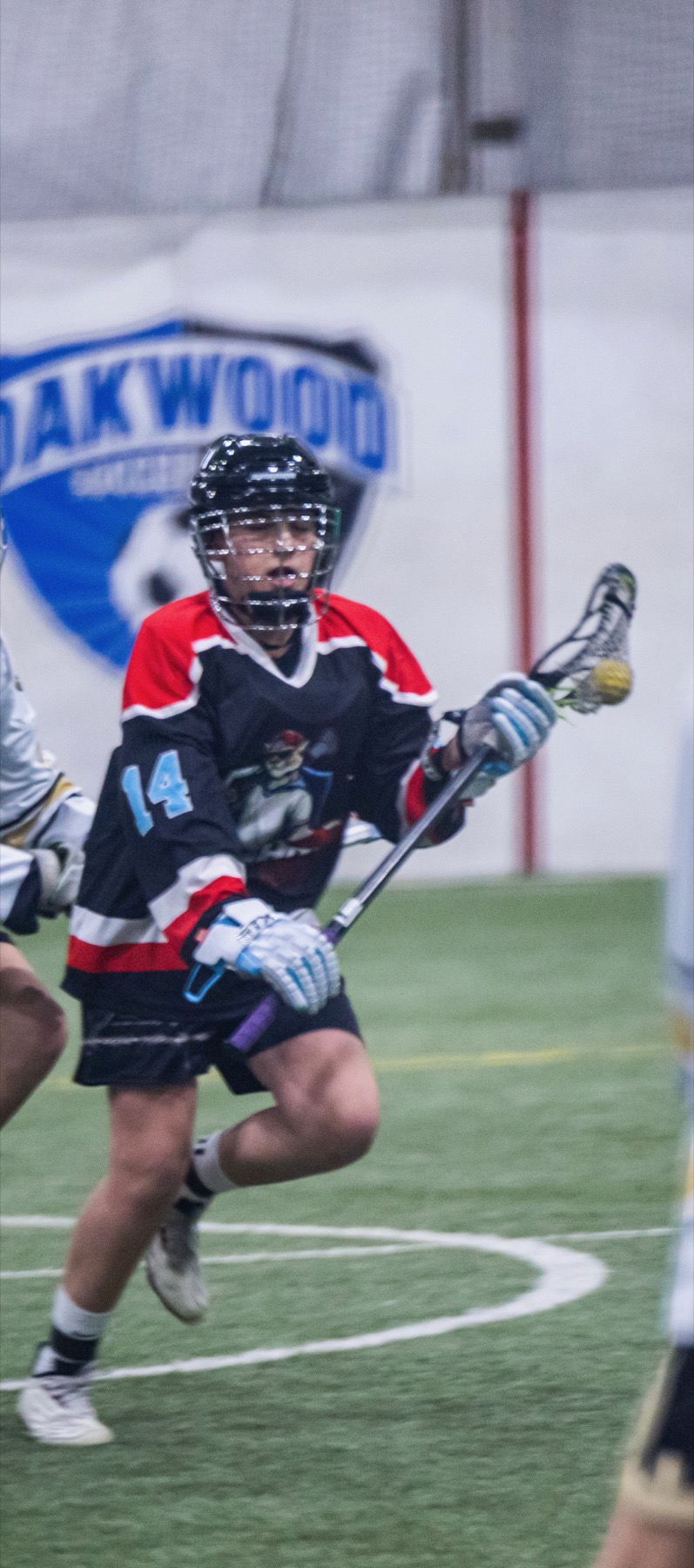 Kougarz box lacrosse player cradling the ball during a tournament game