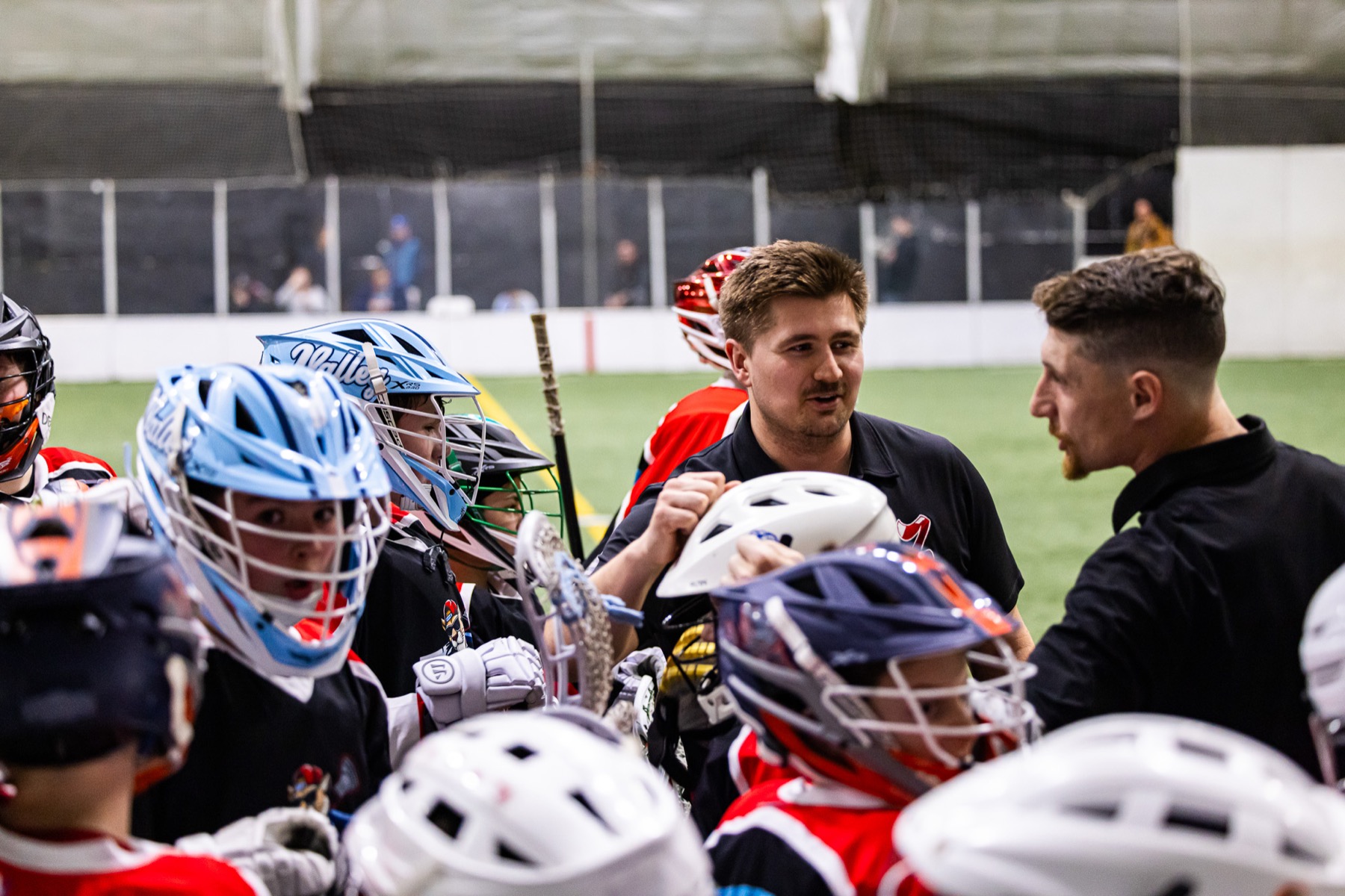 Kougarz coaches working with players at practice