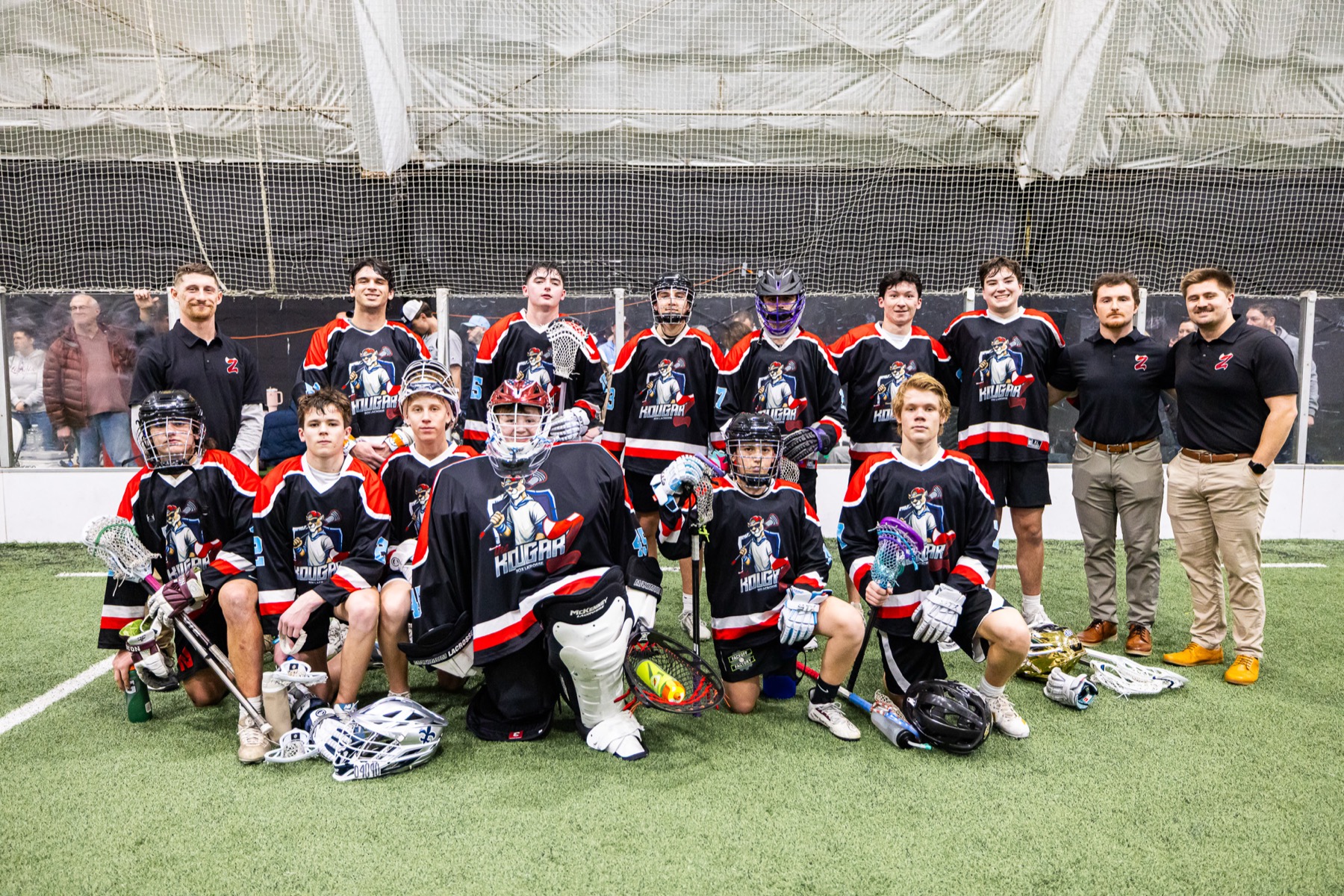 Kougarz box lacrosse team on the field with coaches